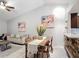 Open-concept living room with high ceilings, neutral decor, and dining area at 2724 Shelby Ruth Pl, St Cloud, FL 34769