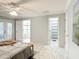 Bright main bedroom with a ceiling fan, backyard access, and neutral decor at 2724 Shelby Ruth Pl, St Cloud, FL 34769