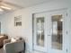 The sun room has neutral walls and marble floors with seating and double doors at 2724 Shelby Ruth Pl, St Cloud, FL 34769