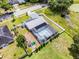 Aerial view of backyard featuring a screened-in pool, solar panels, and playground equipment at 2832 Buccaneer Dr, Winter Park, FL 32792