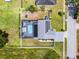 A bird's-eye view reveals a fenced yard, a screened-in pool, and solar panels on the roof at 2832 Buccaneer Dr, Winter Park, FL 32792