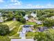 Aerial shot of a beautiful home with solar panels, screened pool, fenced yard, and stunning water views at 2832 Buccaneer Dr, Winter Park, FL 32792