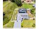 Aerial view of a beautiful home with a solar panel roof, screened-in pool, and fenced yard at 2832 Buccaneer Dr, Winter Park, FL 32792