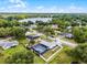 Aerial view showcases the home's screened pool, solar panels, and lakeside community at 2832 Buccaneer Dr, Winter Park, FL 32792