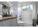 Well-lit bathroom with marble tile features a tub and shower combination with a stylish vanity at 2832 Buccaneer Dr, Winter Park, FL 32792