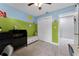 A charming bedroom boasts a storage bench, painted walls, and access to additional living space at 2832 Buccaneer Dr, Winter Park, FL 32792