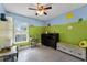 Bright bedroom with colorful wall decor, tiled flooring, a ceiling fan, and a window at 2832 Buccaneer Dr, Winter Park, FL 32792