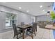 Inviting dining area with an open layout, modern table, seating for four, and open views to living room at 2832 Buccaneer Dr, Winter Park, FL 32792