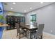 Dining room with a wooden table, four chairs, display cabinet, and a view of the screened lanai at 2832 Buccaneer Dr, Winter Park, FL 32792