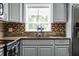 Kitchen sink with window view, granite counters, tile backsplash and ample cabinet space at 2832 Buccaneer Dr, Winter Park, FL 32792