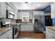 Updated kitchen featuring stainless steel appliances, granite countertops and wood flooring, creating a modern aesthetic at 2832 Buccaneer Dr, Winter Park, FL 32792