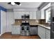 Updated kitchen with stainless steel appliances, granite counters, and tile backsplash at 2832 Buccaneer Dr, Winter Park, FL 32792