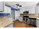 Updated kitchen with stainless steel appliances, granite counters, and tile backsplash at 2832 Buccaneer Dr, Winter Park, FL 32792
