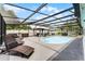 Spacious screened-in pool area with lounge chairs, outdoor dining, and a refreshing pool at 2832 Buccaneer Dr, Winter Park, FL 32792