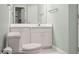 Bathroom with a toilet, vanity and sink, a large mirror and view of the shower and bath at 2880 Old Castle Dr, Winter Park, FL 32792
