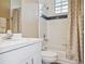 Bright bathroom featuring a bathtub, white vanity and sink, plus elegant neutral-toned shower curtains at 2880 Old Castle Dr, Winter Park, FL 32792
