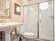 Modern bathroom offers a pedestal sink, updated fixtures, and a stylish glass-enclosed shower at 2880 Old Castle Dr, Winter Park, FL 32792