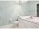 Well-lit bathroom with a white vanity, toilet, and a large mirror above the sink at 2880 Old Castle Dr, Winter Park, FL 32792
