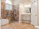 Elegant bathroom features a tiled shower, soaking tub, vanity, and updated fixtures at 2880 Old Castle Dr, Winter Park, FL 32792