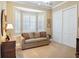 Comfortable bedroom features neutral colors, bay window, and versatile seating area at 2880 Old Castle Dr, Winter Park, FL 32792