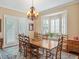 Traditional dining room featuring a wooden table, chairs, and bay window for natural light at 2880 Old Castle Dr, Winter Park, FL 32792