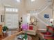 Grand foyer with a staircase, natural light, and stylish decor, creating a welcoming ambiance at 2880 Old Castle Dr, Winter Park, FL 32792