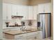 Well-equipped kitchen with stainless steel appliances, granite countertops, and white cabinetry at 2880 Old Castle Dr, Winter Park, FL 32792