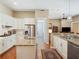 Expansive kitchen with granite countertops, stainless steel appliances and adjacent casual dining space at 2880 Old Castle Dr, Winter Park, FL 32792