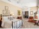 Spacious main bedroom features a brass bed frame, neutral walls, and comfortable sitting area at 2880 Old Castle Dr, Winter Park, FL 32792