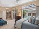 Inviting main bedroom offers pool views, four-poster bed, seating area, and natural light at 2880 Old Castle Dr, Winter Park, FL 32792