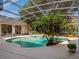 Screened-in backyard pool surrounded by lush landscaping, creating a private oasis at 2880 Old Castle Dr, Winter Park, FL 32792