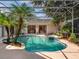 Beautiful pool area with a spa, palm trees, and screened enclosure for year-round enjoyment at 2880 Old Castle Dr, Winter Park, FL 32792