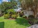 Well-manicured yard with tropical landscaping and green grass at 2880 Old Castle Dr, Winter Park, FL 32792