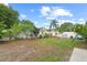 Spacious backyard with a white fence, green grass, and plenty of space for outdoor activities at 298 Clydesdale Cir, Sanford, FL 32773