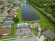 Aerial shot of community amenities including pool, playground, parking, and green space adjacent to a lake at 298 Clydesdale Cir, Sanford, FL 32773