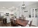 Dining room with modern light fixture open to kitchen, with plenty of natural light at 298 Clydesdale Cir, Sanford, FL 32773