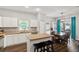 Bright kitchen featuring white cabinets, stainless steel appliances, and an island with a breakfast bar at 298 Clydesdale Cir, Sanford, FL 32773