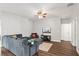 Comfortable living room boasts ceiling fan, neutral paint, and wood flooring at 298 Clydesdale Cir, Sanford, FL 32773