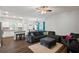 Spacious living room seamlessly connects to kitchen and dining areas, featuring modern furnishings at 298 Clydesdale Cir, Sanford, FL 32773