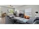 Spacious living room featuring a comfortable sofa, modern furnishings, and large windows at 298 Clydesdale Cir, Sanford, FL 32773