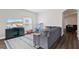 Inviting living room with a cozy sofa, TV, and an area rug on wood floors at 298 Clydesdale Cir, Sanford, FL 32773
