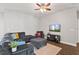 Cozy living room features ceiling fan, neutral paint, and wood flooring at 298 Clydesdale Cir, Sanford, FL 32773