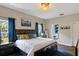 Comfortable main bedroom with dark wood furniture, and plenty of natural light at 298 Clydesdale Cir, Sanford, FL 32773