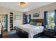 Comfortable main bedroom with dark wood furniture, book shelves, and plenty of natural light at 298 Clydesdale Cir, Sanford, FL 32773