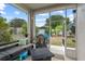 Relaxing screened-in patio with comfortable seating, fire table, and a view of the backyard at 298 Clydesdale Cir, Sanford, FL 32773
