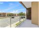 Relax on the balcony with a community view and glass railing, with a peek inside through sliding doors at 3149 Brasilia Ave, Kissimmee, FL 34747