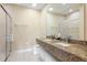 Spacious bathroom with double sinks, granite countertop, and glass enclosed shower at 3149 Brasilia Ave, Kissimmee, FL 34747