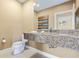 Well-lit bathroom featuring a granite countertop, modern fixtures, and neutral color scheme at 3149 Brasilia Ave, Kissimmee, FL 34747