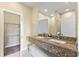 Elegant bathroom featuring a double vanity with granite countertop and a large walk-in closet at 3149 Brasilia Ave, Kissimmee, FL 34747
