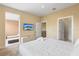 Bright bedroom with large bed, ensuite bathroom, TV, and neutral decor at 3149 Brasilia Ave, Kissimmee, FL 34747
